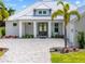 Front entrance of home featuring a metal roof, brick paver driveway and landscaping at 28960 Gin Ln, Punta Gorda, FL 33982