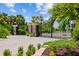 Gated entrance to The Estates on Peace River surrounded by lush landscaping and mature palms at 28960 Gin Ln, Punta Gorda, FL 33982