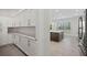 Open kitchen with a butler's pantry, stainless fridge, and island with a marble counter at 28960 Gin Ln, Punta Gorda, FL 33982