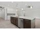 Modern kitchen island with stainless dishwasher, sink, pendant lighting and marble counter at 28960 Gin Ln, Punta Gorda, FL 33982
