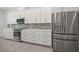 Bright kitchen featuring stainless appliances, a gas range, white cabinetry and backsplash at 28960 Gin Ln, Punta Gorda, FL 33982