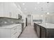 Spacious kitchen featuring stainless appliances, an island, white cabinets and backsplash at 28960 Gin Ln, Punta Gorda, FL 33982