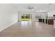 Open-concept living area with tile flooring, high ceilings and large glass sliding doors at 28960 Gin Ln, Punta Gorda, FL 33982