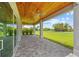 The back patio has a wood plank ceiling, ceiling fans, and large format pavers for outdoor living at 28960 Gin Ln, Punta Gorda, FL 33982