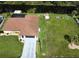 Aerial view of property showing a spacious yard with a utility shed, pool area, and canal access at 319 Kindred Blvd, Port Charlotte, FL 33954