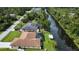 Aerial view of a home with pool, canal, and spacious yard, showcasing waterfront property and outdoor living at 319 Kindred Blvd, Port Charlotte, FL 33954