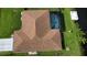 Birds eye view of a home with a pool, well maintained landscaping, and canal access at 319 Kindred Blvd, Port Charlotte, FL 33954