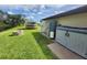 Well maintained back yard with a fire pit, dock, water equipment, and lush landscaping at 319 Kindred Blvd, Port Charlotte, FL 33954