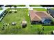 Spacious backyard features a pool, shed, and ample green space for outdoor activities and entertaining at 319 Kindred Blvd, Port Charlotte, FL 33954