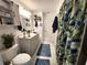 Bathroom featuring a vanity, shower with green leaf curtain, and white door at 319 Kindred Blvd, Port Charlotte, FL 33954