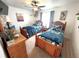 Comfortable bedroom with two beds, ceiling fan, and soft lighting at 319 Kindred Blvd, Port Charlotte, FL 33954