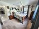 Bedroom featuring a bed, side table, and window with gray curtains at 319 Kindred Blvd, Port Charlotte, FL 33954