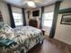 Bright bedroom featuring palm tree bedding, a ceiling fan, and a flatscreen television at 319 Kindred Blvd, Port Charlotte, FL 33954