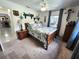 Bedroom featuring a bed, side table, and desk in the corner behind an open door at 319 Kindred Blvd, Port Charlotte, FL 33954
