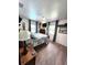 Bedroom featuring a bed, mounted television, ceiling fan and windows with curtains at 319 Kindred Blvd, Port Charlotte, FL 33954