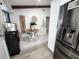 Cozy breakfast nook with a round table, white chairs, and modern appliances at 319 Kindred Blvd, Port Charlotte, FL 33954