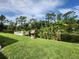 Charming backyard with a dock on the water, a wishing well, and lush tropical landscaping at 319 Kindred Blvd, Port Charlotte, FL 33954