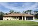 Charming home featuring a well-maintained lawn, a neutral color scheme, and a spacious screened garage at 319 Kindred Blvd, Port Charlotte, FL 33954