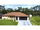 Charming home featuring a well-maintained lawn, a neutral color scheme, and a spacious screened garage at 319 Kindred Blvd, Port Charlotte, FL 33954