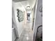 Long hallway with art on the walls and access to other rooms in the house at 319 Kindred Blvd, Port Charlotte, FL 33954