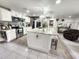 Spacious kitchen featuring stainless steel appliances, a large island, and bright white cabinets at 319 Kindred Blvd, Port Charlotte, FL 33954