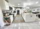An open kitchen design with stainless steel appliances, a large island, and decorative elements at 319 Kindred Blvd, Port Charlotte, FL 33954