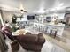 Open-concept living room and kitchen with a center island, pendant lights, and modern furnishings at 319 Kindred Blvd, Port Charlotte, FL 33954