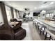Open-concept living space features a large island with seating, modern finishes, and comfortable furniture at 319 Kindred Blvd, Port Charlotte, FL 33954