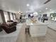 Open-concept living space features a large island with seating, modern finishes, and comfortable furniture at 319 Kindred Blvd, Port Charlotte, FL 33954
