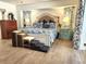 A serene bedroom with blue and white bedding, side tables, and decorative curtains at 319 Kindred Blvd, Port Charlotte, FL 33954
