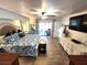 This main bedroom features cool toned walls, wood floors, with pool views and ample space at 319 Kindred Blvd, Port Charlotte, FL 33954
