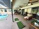 Spacious screened patio features comfortable seating, a grill, and pool access at 319 Kindred Blvd, Port Charlotte, FL 33954
