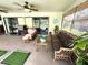 Covered patio features comfortable seating, a grill, and serene view of screened pool at 319 Kindred Blvd, Port Charlotte, FL 33954