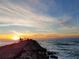 Picturesque sunset over a pier where people are gathered, highlighting a beautiful coastal scene at 319 Kindred Blvd, Port Charlotte, FL 33954