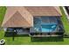 Aerial view of screened-in pool with pool floats, attached to home with brown roof at 319 Kindred Blvd, Port Charlotte, FL 33954