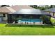 Screened-in pool with heart shape, potted plants, and garden statues in a well maintained fenced-in yard at 319 Kindred Blvd, Port Charlotte, FL 33954