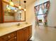 Bathroom with vanity, sink, mirror, pendant lights, and natural light from a skylight at 3456 Highlands Rd, Punta Gorda, FL 33983