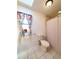 Bathroom showcasing a toilet, shower/tub, and a window with colorful curtains at 3456 Highlands Rd, Punta Gorda, FL 33983