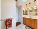Bathroom featuring wood cabinets, a mirror, pendant lights, and a colorful towel at 3456 Highlands Rd, Punta Gorda, FL 33983