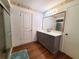 Bathroom with wood floors features a new vanity with a large mirror and a glass door shower at 3456 Highlands Rd, Punta Gorda, FL 33983