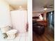 Bright bathroom featuring a toilet and shower with curtain, next to an open bedroom at 3456 Highlands Rd, Punta Gorda, FL 33983