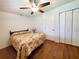 Comfortable bedroom with hardwood floors, ceiling fan, and closet space at 3456 Highlands Rd, Punta Gorda, FL 33983
