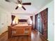 Bedroom with wood flooring, a ceiling fan, and lots of natural light from large windows at 3456 Highlands Rd, Punta Gorda, FL 33983