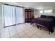 Bedroom features tile floors, a decorative folding screen, and a window offering natural light at 3456 Highlands Rd, Punta Gorda, FL 33983