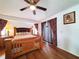 Well-lit bedroom with hardwood floors, ceiling fan, and coordinated window coverings at 3456 Highlands Rd, Punta Gorda, FL 33983
