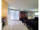 Bedroom features tile floors, a decorative folding screen, and a window offering natural light at 3456 Highlands Rd, Punta Gorda, FL 33983