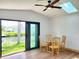 Bright dining area featuring wood floors, a glass table with seating and a skylight at 3456 Highlands Rd, Punta Gorda, FL 33983