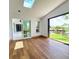 Dining area featuring wood floors and views of the backyard and canal at 3456 Highlands Rd, Punta Gorda, FL 33983