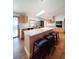 Large kitchen island with seating, stainless appliances, hardwood floors, and skylight at 3456 Highlands Rd, Punta Gorda, FL 33983
