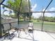 Screened-in patio featuring a cozy seating area, perfect for enjoying the outdoors while protected at 3456 Highlands Rd, Punta Gorda, FL 33983
